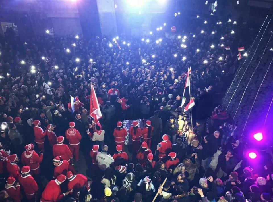 Dozens of residents, including some dressed as Santa, have been pictured enjoying Christmas celebrations as the fighting ends