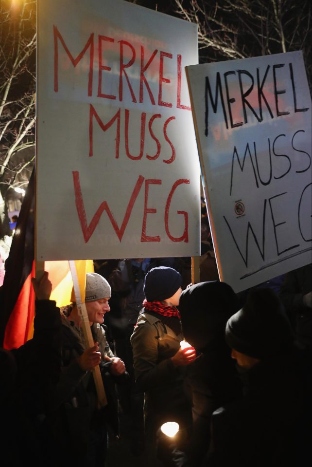  Protesters held signs that read "Merkel must go"