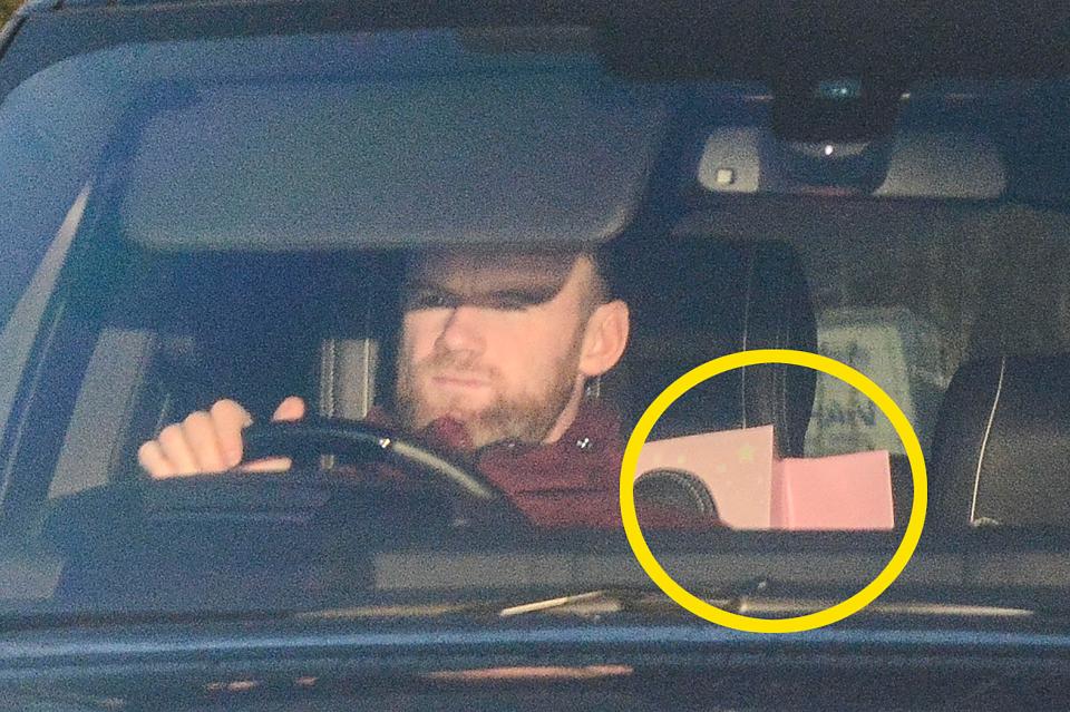  Wayne Rooney was spotted arriving with a pair of pink gift bags