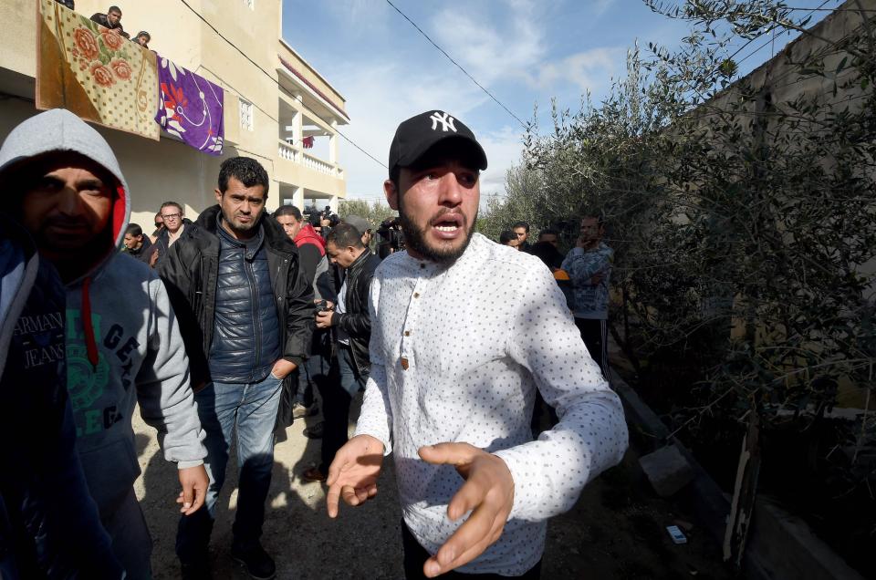  The suspect's brother Abdelkader Amri, 24, is pictured outside his home in the Tunisian town of Oueslatia