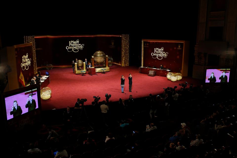  School children sing out the prize numbers of Spain's Christmas lottery at the Royal Theater in Madrid