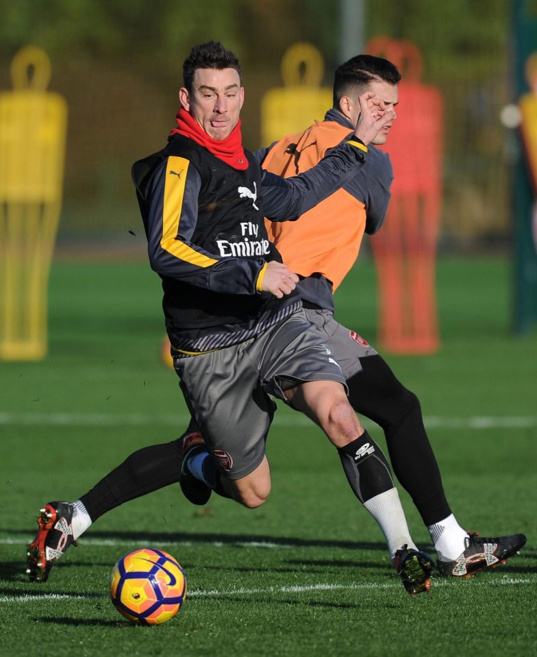  Laurent Koscielny battles for the ball at training