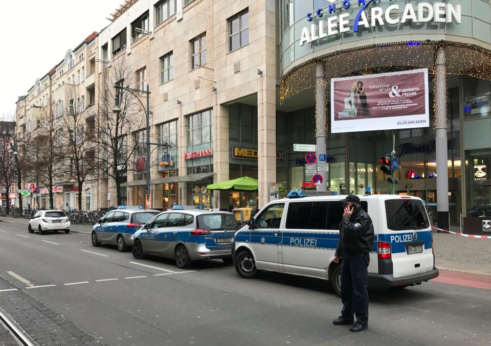  Cops vans are pictured outside a shopping centre after a bomb alert