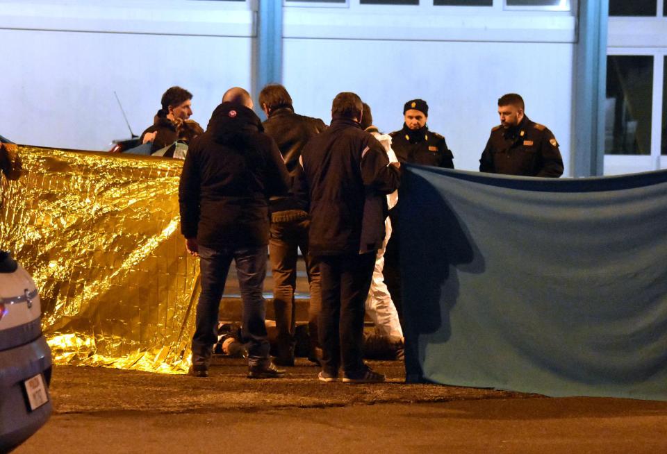  Police teams covered the body in the Milan square after the shoot-out at around 3am this morning local time