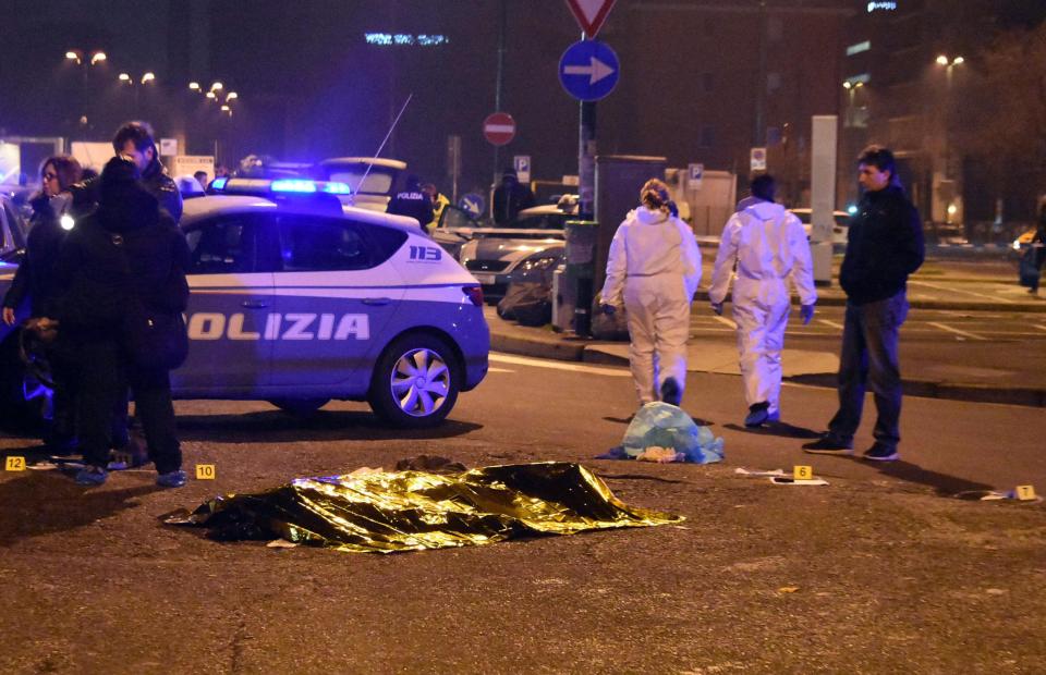  The body is covered with a thermic blanket near a train station in Milan