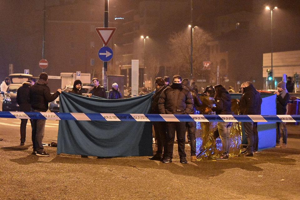  Italian police and forensics gathered around the body of Berlin truck terrorist after he was shot by rookie cop Luca Scata