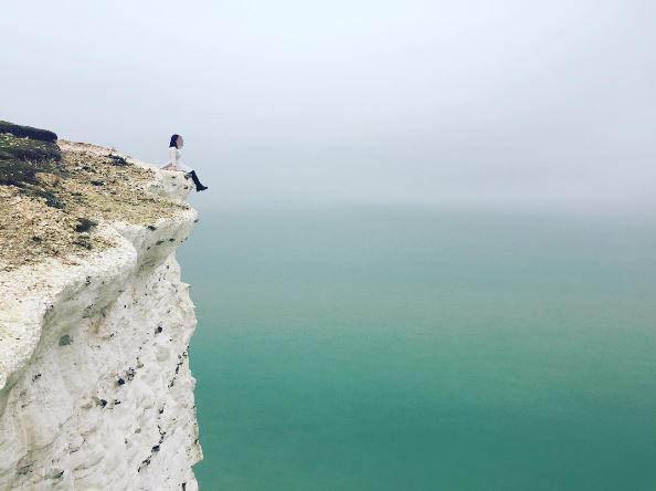  The same woman in the cream coat takes her turn to sit dangerously on the edge to get that perfect profile picture