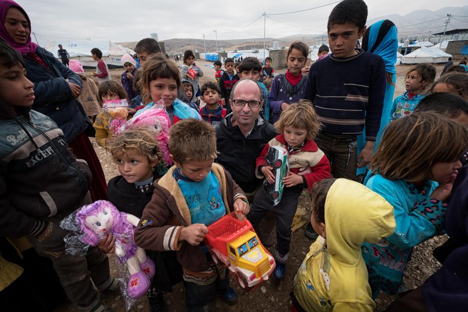  Kids cling on to donations in the Zelikan camp in Iraq