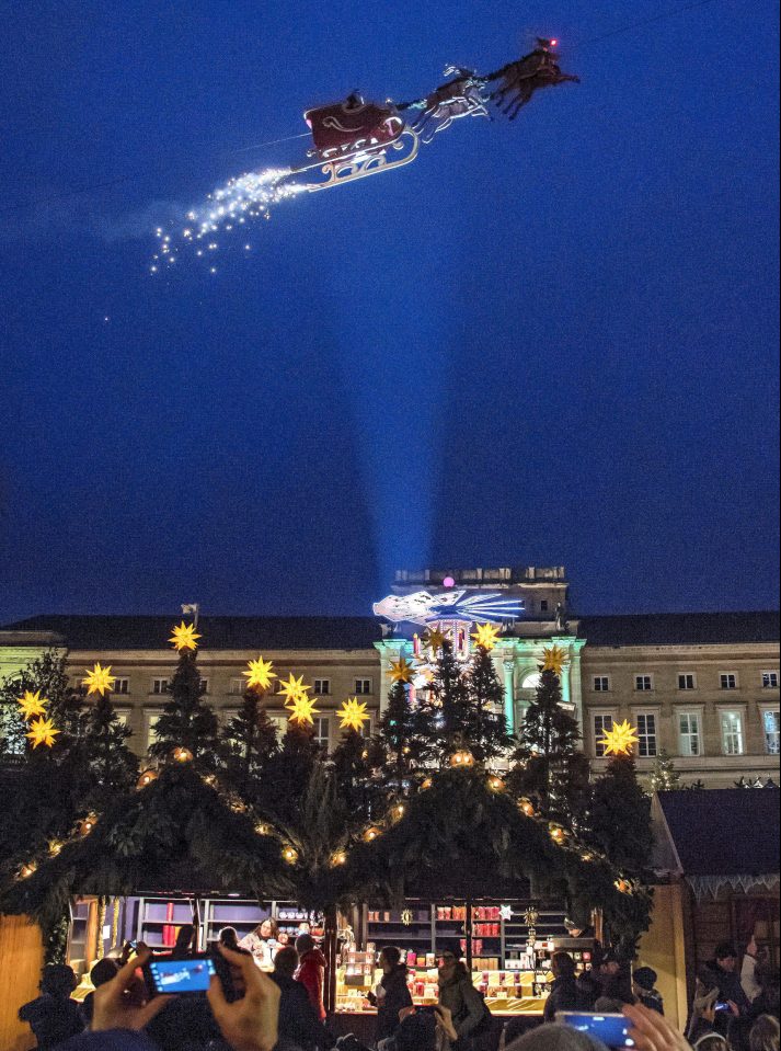  Father Christmas soars above the crowd