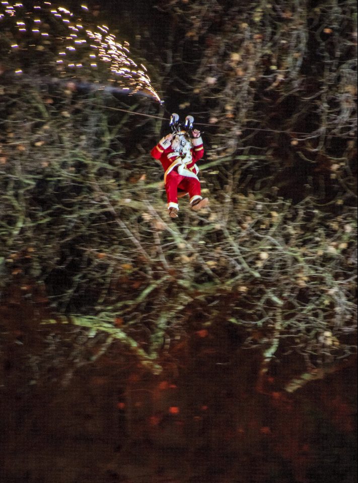  Santa zip-lines over the crowd, much to their delight