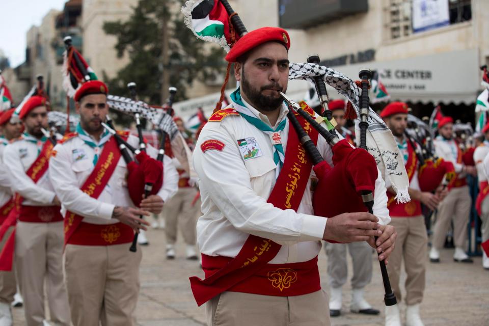  A Palestinian bagpipe group marches at Manger Square during a Christmas Eve procession