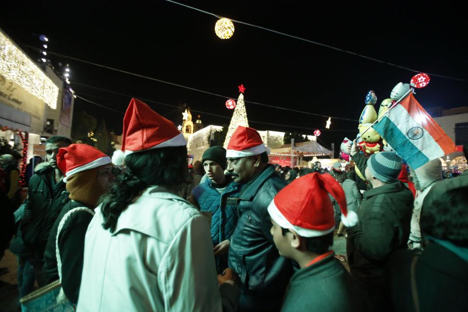  People wear Santa hats as they gather near the spot where it's believed Jesus was born