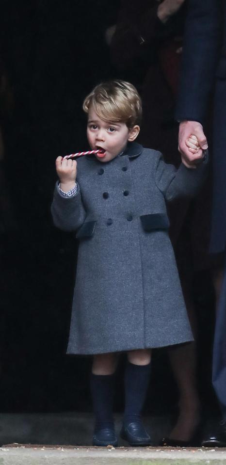  Prince George chews on his candy cane as he leaves the church