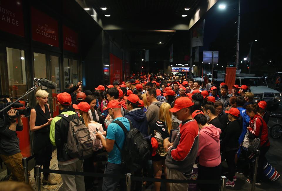  Excited shoppers gather in front of the doors as opening time approaches