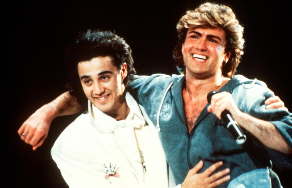  Andrew Ridgeley and George Michael of Wham! performing on stage in 1985