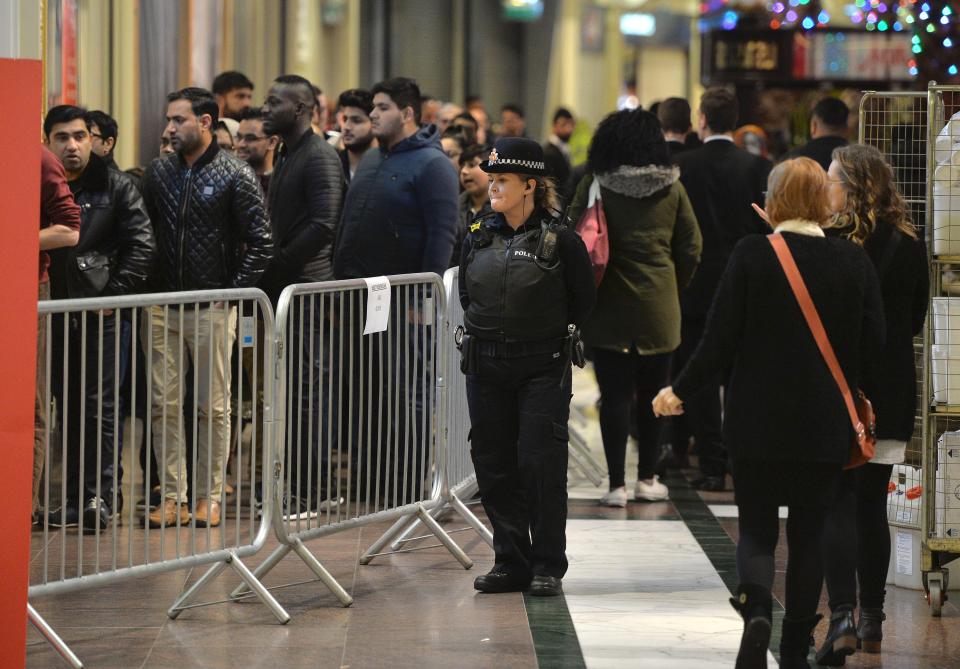  A police officer guards shopping queues in Manchester