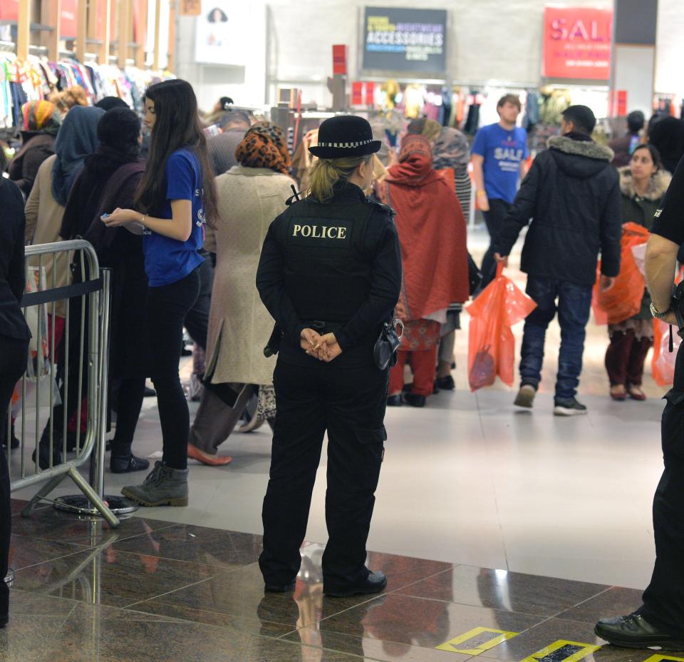  A police officer monitors Boxing Day shoppers