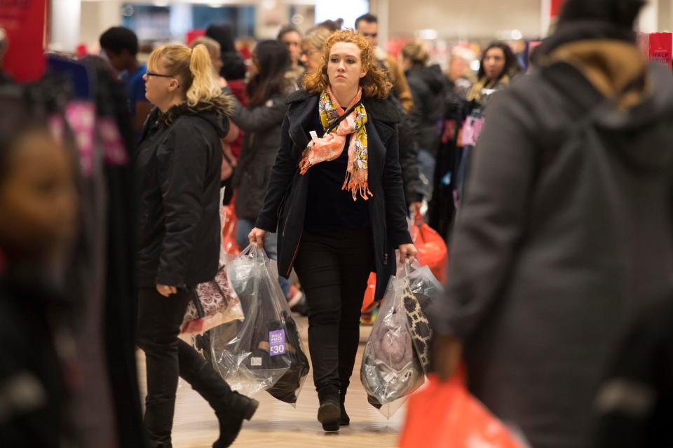  A woman carries bags through while shopping on the Cardiff high street