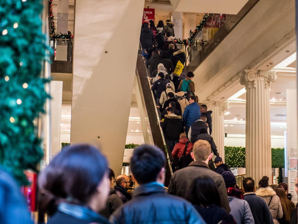  Selfridges customers in London file onto the store's escalators