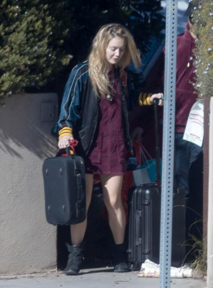  Billie is spotted lugging around some suitcases outside the house