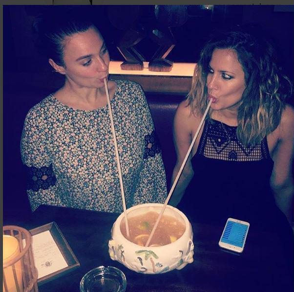  Caroline Flack has been sharing pictures of herself downing cocktails with a female friend