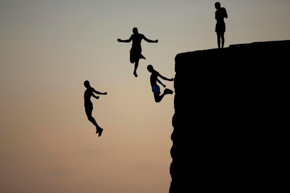  Israeli Arab boys jump into the Mediterranean sea from the ancient wall surrounding the old city of Acre, northern Israel