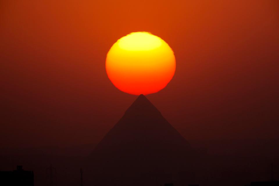  The sun sets over the the Giza Pyramids, near Cairo, Egypt