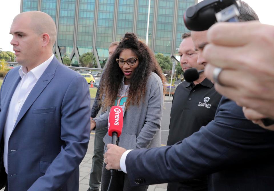  Serena Williams is followed by media as she is escorted to a car on her arrival at Auckland Airport in New Zealand