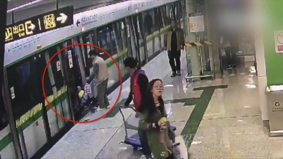  'Best father of the year' ... shocking moment man uses buggy to keep closing train door open