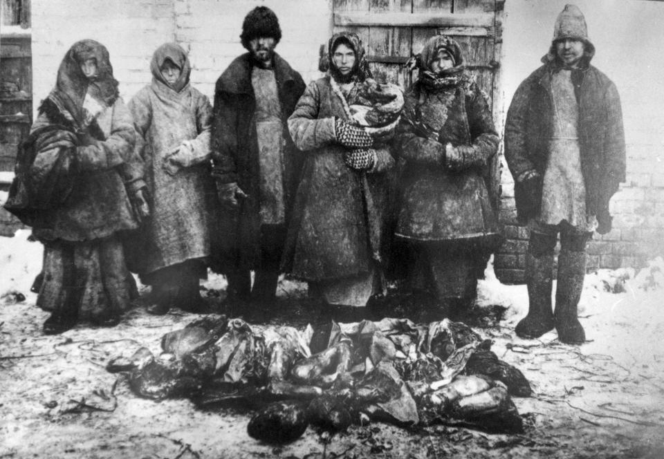  A family in the Volga region pose beside human remains