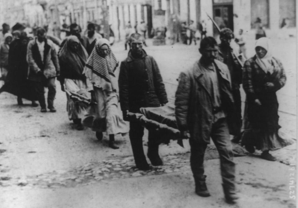  Two small coffins being carried on stretchers to a cemetery in the Volga famine district of Bolshevist Russia