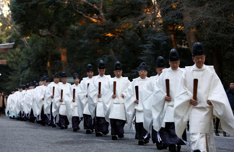  Shinto priests walk in a line to attend a ritual to usher in the upcoming New Year at the Meiji Shrine in Tokyo, Japan