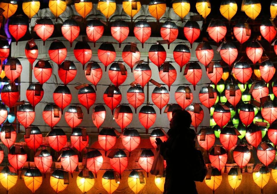  A woman prays in front of lanterns to celebrate the new year at Chogye Buddhist temple in Seoul, South Korea