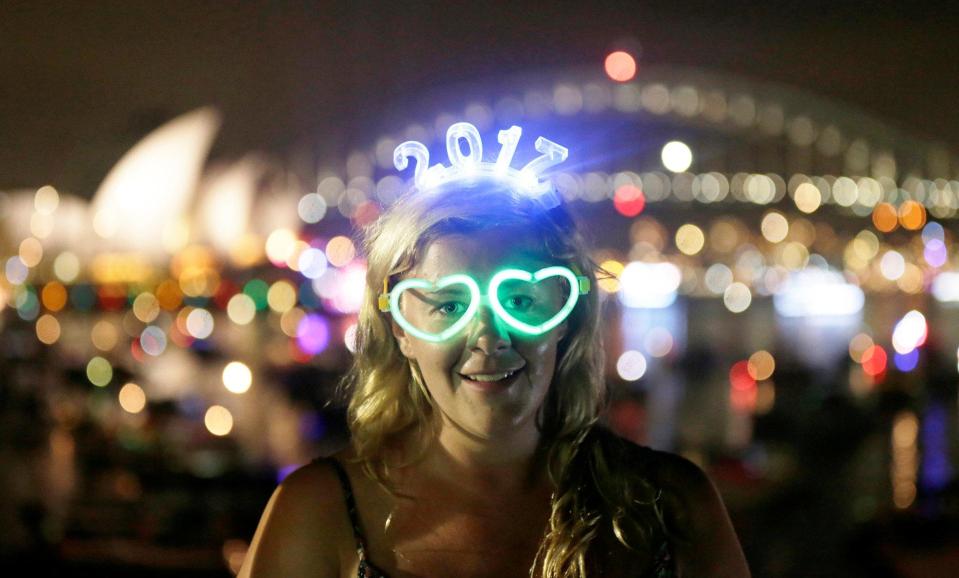  Charlotte Kent from Huddersfield in England wears glowing glasses and a headset for 2017 before watching the New Year's Eve fireworks in Sydney, Australia