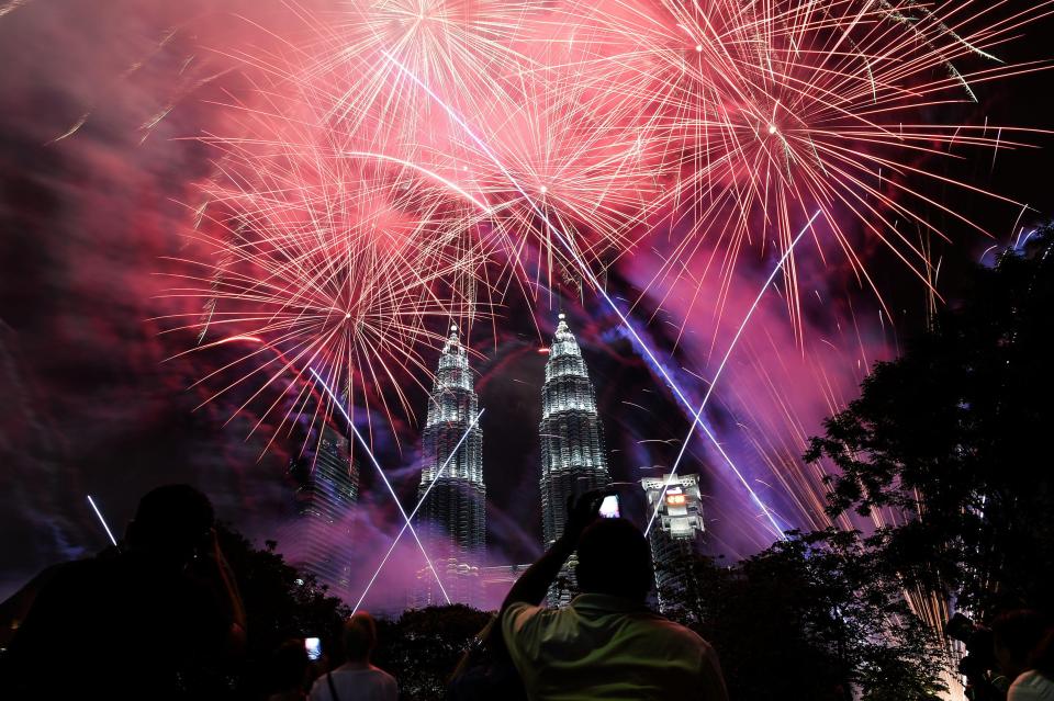  Fireworks illuminate the sky near Malaysia's landmark Petronas Twin Towers during the New Year celebrations in Kuala Lumpur