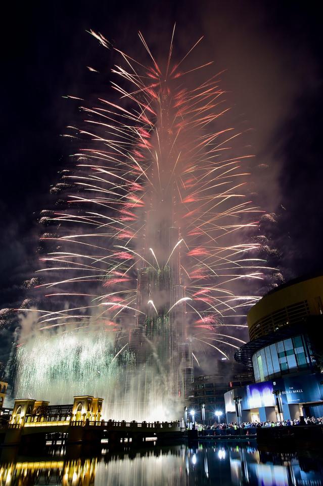  Fireworks illuminate the night sky around, the Burj Khalifa, the tallest building in the world on occasion of the new year of 2017 in Dubai, United Arab Emirates