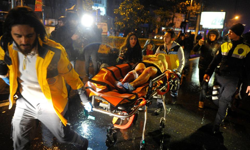  Paramedics rush the wounded to ambulances after the Istanbul nightclub attack