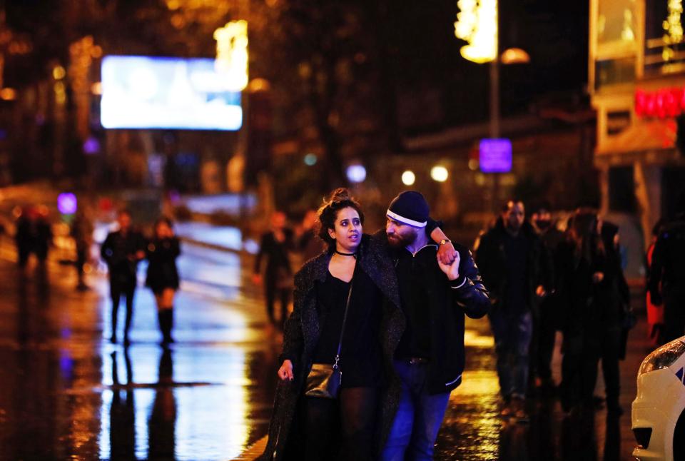  Young revellers limp away from the scene of the bloody massacre