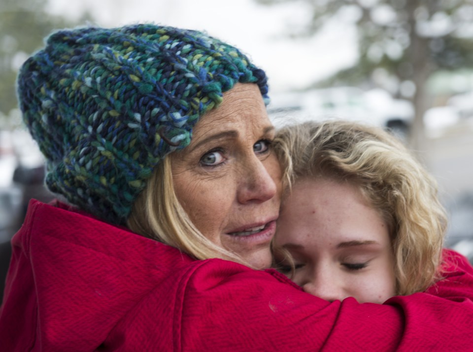  DeAnne Bailey hugs her daughter Halissa, after the incident