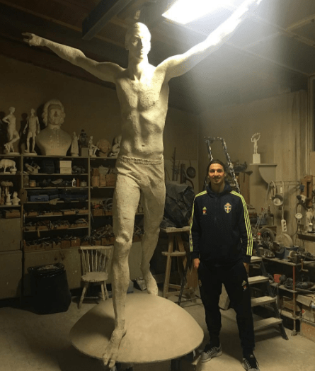  Zlatan Ibrahimovic stands next to the statue being erected in his honour