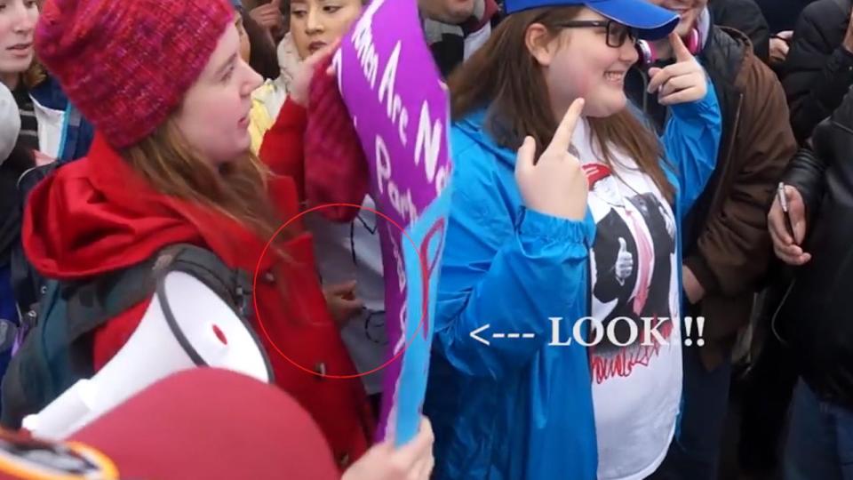  The footage shows a hand holding a lighter reaching out at the Trump supporter taking a picture