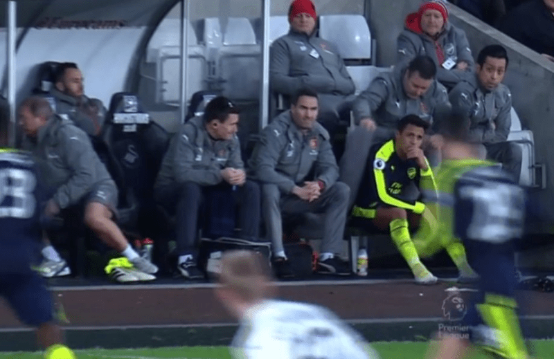  A member of Arsenal's backroom staff wrapped a coat around Sanchez