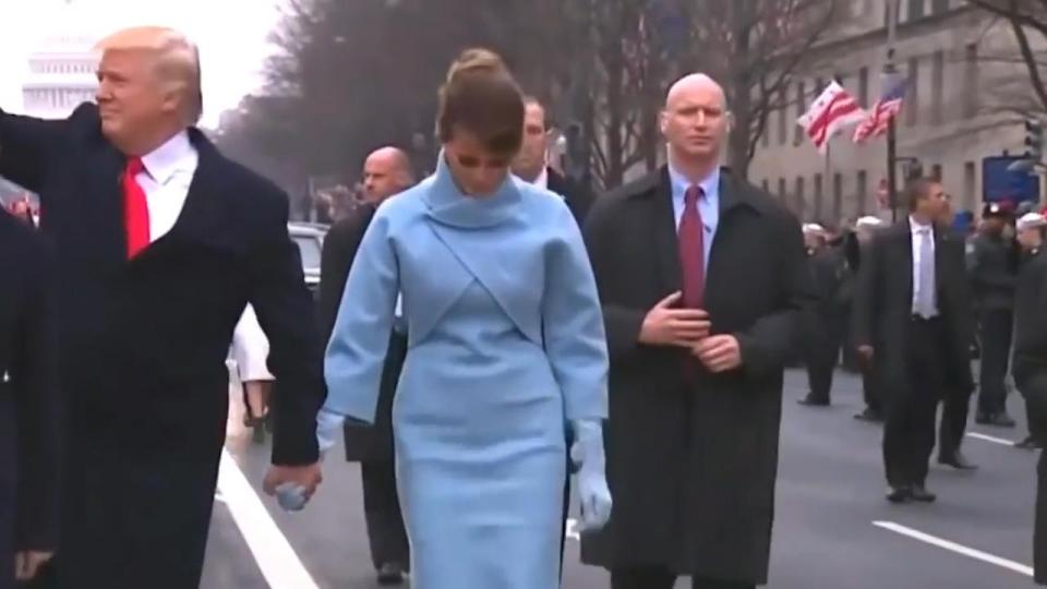  The agent appeared tense as he walked behind the new First Lady while thousands of supporters lined the streets