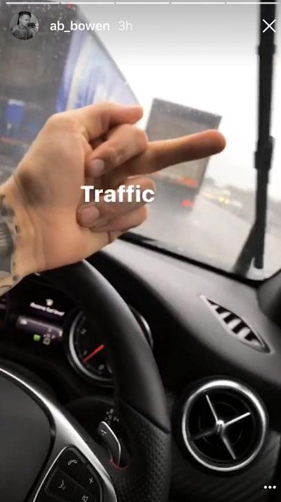 Alex gives the middle finger to "traffic" as he records himself while driving