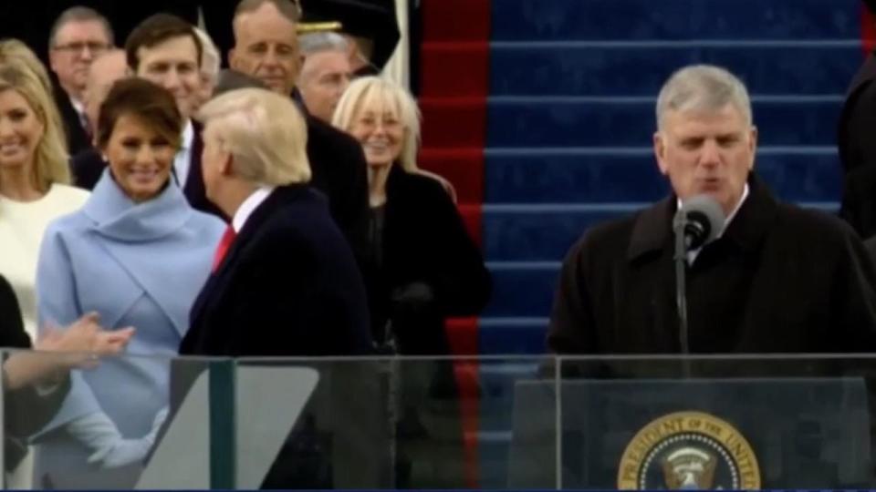  Trump laps up the adoration of the crowd as Melania looks on - smiling at him