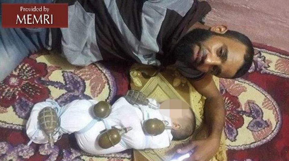  The man was arrested after posing in this photograph with a baby strapped to hand grenades