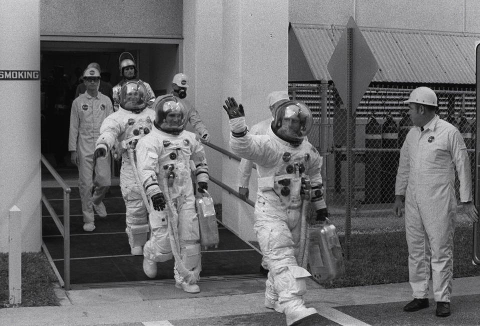  Former astronaut Charles "Pete" Conrad waves as he and Richard Gordon, centre, and Alan Bean leave to the launch pad for their Apollo 12 moon flight in November 1969