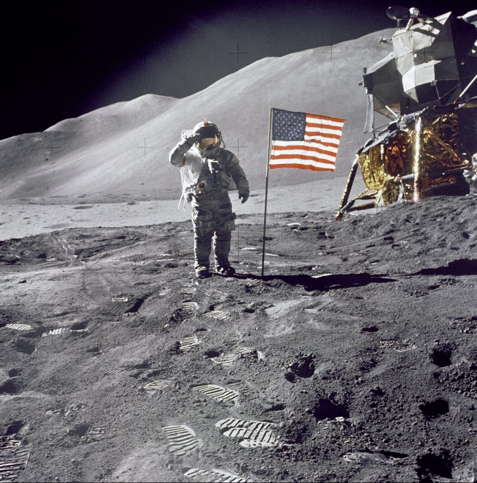  Astronaut David Scott gives a military salute while standing beside the deployed US flag during the Apollo 15 mission