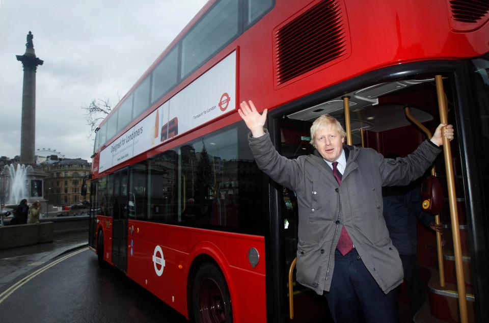  Boris Johnson poses with the double decker buses he introduced as Mayor of London