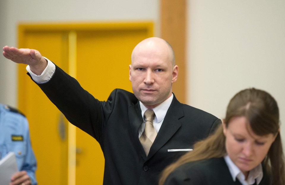 Norwegian mass killer Anders Behring Breivik makes a Nazi salute as he arrives to a makeshift court in Skien Prison where a court agreed his human rights had been violated